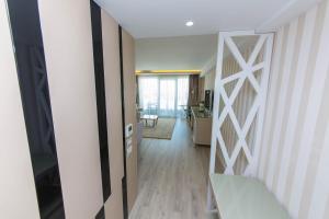 a hallway with a door leading to a living room at Demi Hotel in Sarandë