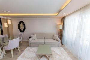 a living room with a couch and a table at Demi Hotel in Sarandë