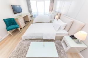 a living room with two beds and a couch at Demi Hotel in Sarandë