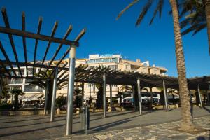 a building with palm trees in front of it at La Sort Boutique Hotel in Moraira