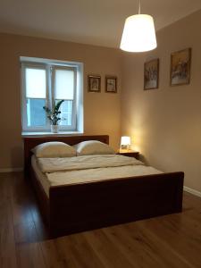 a bedroom with a large bed with a window at Staszica Centrum in Lublin