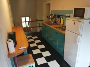 a kitchen with a white refrigerator and a table at Flora in Drivenik