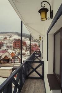 a balcony of a building with a view of a town at Hotel Monysto in Bukovel
