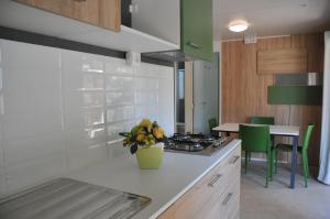 a kitchen with a counter top with a vase of flowers at Villaggio Camping Torre Salinas in Muravera