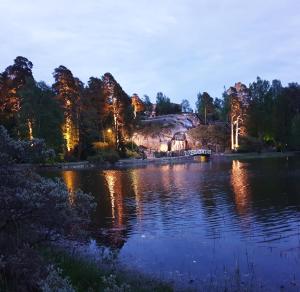 a view of a lake at night with trees at Apartments N & P in Kotka