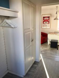 a white door in a room with a red couch at Cozee Central Apartments in Stavanger