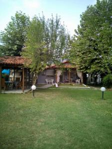 a house with a grass yard and a building at Sevi Platamon Home in Platamonas