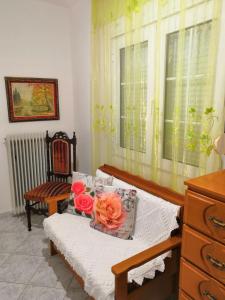 a bedroom with a bed with flowers on it at Sotiris Idyllic Garden House in Kalabaka