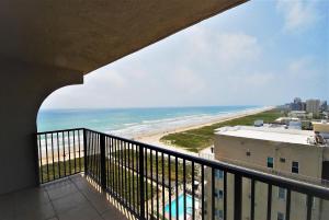 a view of the beach from the balcony of a condo at Ocean Vista Condo Unit #1201 in South Padre Island