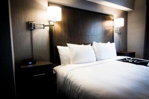 a hotel room with a large bed with white pillows at La Quinta by Wyndham Anchorage Airport in Anchorage