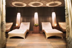a room with two chairs and a table with lights at MÖVENPICK Hotel Hamburg City, historischer Wasserturm im Schanzenpark in Hamburg