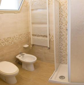 a bathroom with a toilet and a sink and a shower at Casa Vacanze Maria&Vito in Veglie