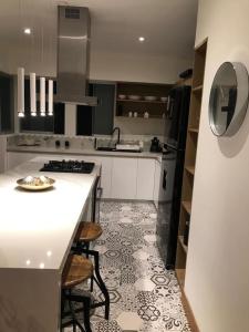 a kitchen with a white counter top and a stove at MLA apartments - Buenos Aires in Lima