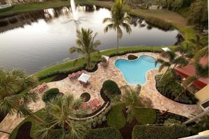 an aerial view of a swimming pool and a lake at Inn at Pelican Bay in Naples