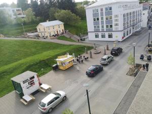 a group of cars parked on a street with a food truck at Centrum Hotel in Akureyri