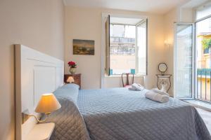 a bedroom with a blue bed and a window at B&B Supportico Lopez in Naples