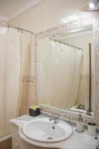 a bathroom with a sink and a mirror at Home By The Sea in Sesimbra