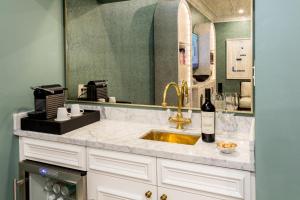 a bathroom with a sink and a mirror at The Lancaster Hotel in Houston
