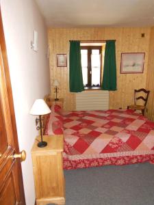 a bedroom with a bed and a window with green curtains at gite tourmalet in Barèges