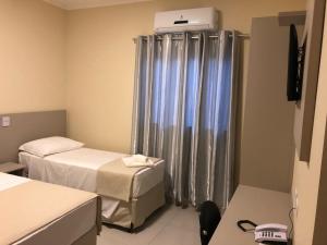 Кровать или кровати в номере Hotel Renascer