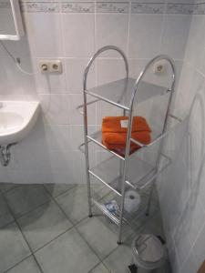 a towel rack in a bathroom next to a sink at Pension Belau's Hof in Stendal