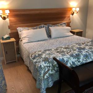 a bedroom with a large bed with a wooden headboard at Gibsons Harbour Retreat in Gibsons