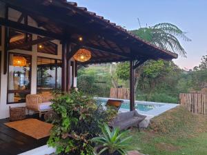 a house with a patio and a swimming pool at Villa Art Hill By The Villas 100 in Cisarua