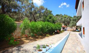 a garden with potted plants sitting on a bench at Villa Maro in Skopelos Town