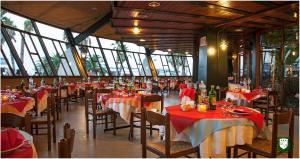 a restaurant with tables and chairs with red tablecloths at Hotel Marconi in Grottammare