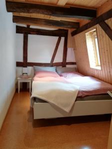 a large bed in a room with wooden ceilings at Ferienwohnung-Hallebach in Zell an der Mosel