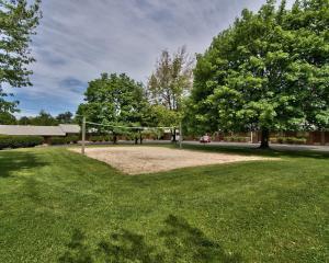 a volley ball net in a field with a tree at Parkview Inn and Conference Center in Allentown