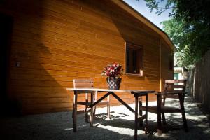 a table with two chairs and a vase of flowers on it at Apartamentos el Bosquet in Sant Cugat del Vallès