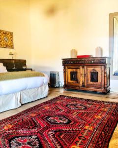 a bedroom with a bed and a rug on the floor at Casa Bouchon Hotel Boutique in San Javier