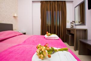 Postel nebo postele na pokoji v ubytování Astron Hotel