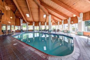 a large swimming pool in a building with a ceiling at SureStay Plus Hotel by Best Western Redding in Redding