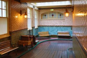 a bowling alley with two benches and a bowling lane at The Midland Hotel in Bradford