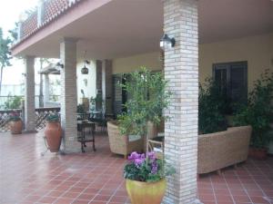 a patio with potted plants on a house at Villa La Spada in Taormina