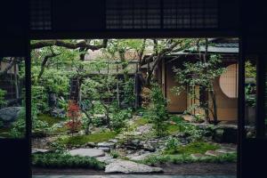 a garden in front of a building at Luxury hotel SOWAKA in Kyoto