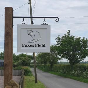 a sign that reads foxes field on a road at Foxes Field B&B Aston Nantwich in Wrenbury