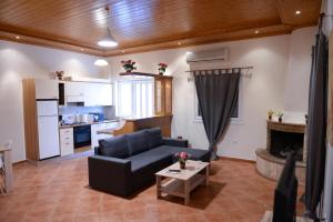 a living room with a couch and a table at Patras Cozy Lodge in Patra