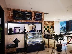 a restaurant with a food court with a counter at InnB Park Hotel in Kuala Lumpur