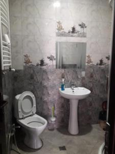 a bathroom with a toilet and a sink at GTNL Aparthotel in Tbilisi City +112 photos
