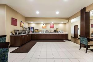 a lobby of a hospital with a counter and chairs at Comfort Suites in Sioux Falls