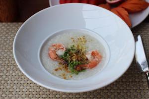 a bowl of soup with shrimp on a table at Banana Fan Sea Resort in Chaweng