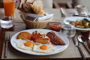 a plate of eggs and other food on a table at Banana Fan Sea Resort in Chaweng