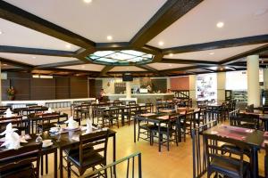 une salle à manger avec des tables et des chaises dans un restaurant dans l'établissement Sir James Resort, à Muak Lek