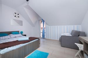 a bedroom with a bed and a desk and a chair at Villa Baltic Karwia in Karwia +140 photos
