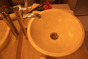 a white sink with a drain in a bathroom at Lycia Hotel in Kaş