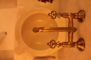 a brass toilet bowl in a bathroom at Lycia Hotel in Kaş