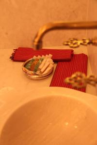 a bathroom counter with a sink and a red towel at Lycia Hotel in Kaş